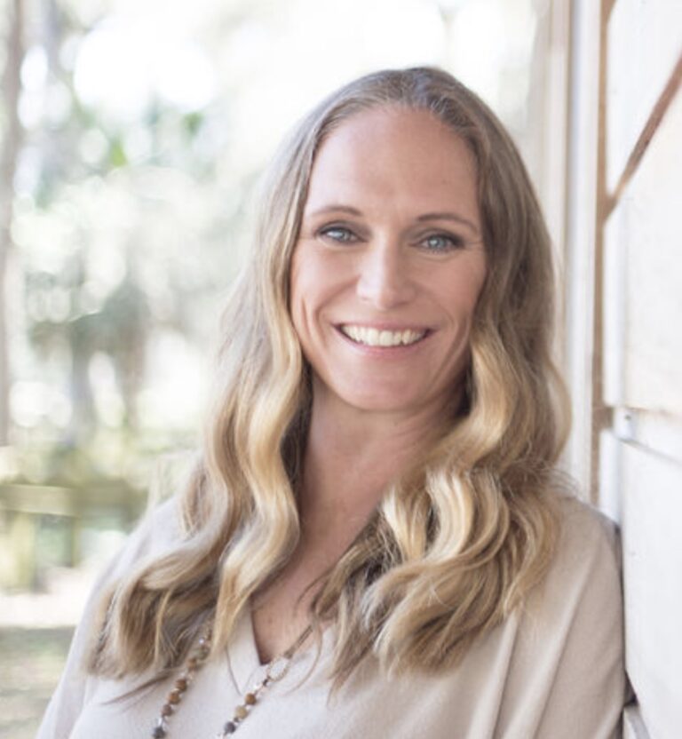 portrait of a blonde woman captured in a bright outdoor setting